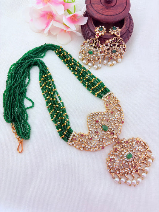 Stylish   beads haram featuring a statement pendant and matching earrings adorned with pearl drops