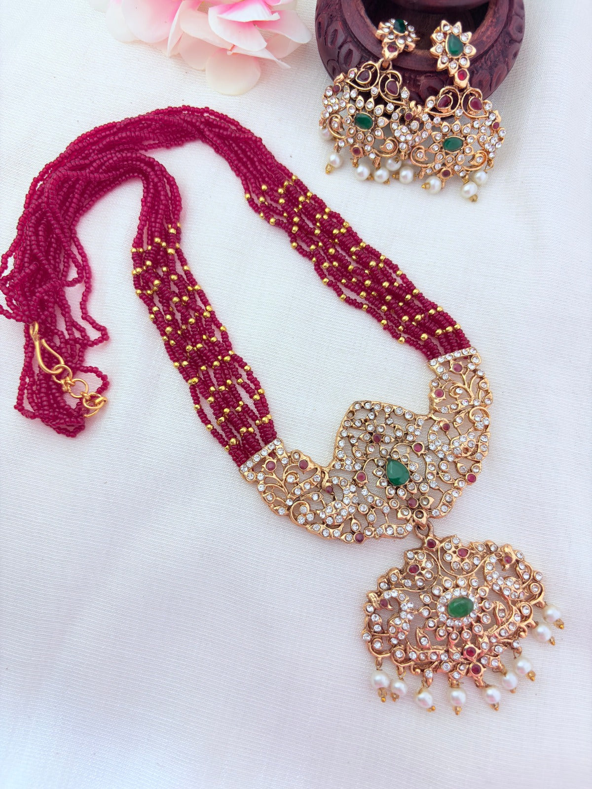 Stylish   beads haram featuring a statement pendant and matching earrings adorned with pearl drops