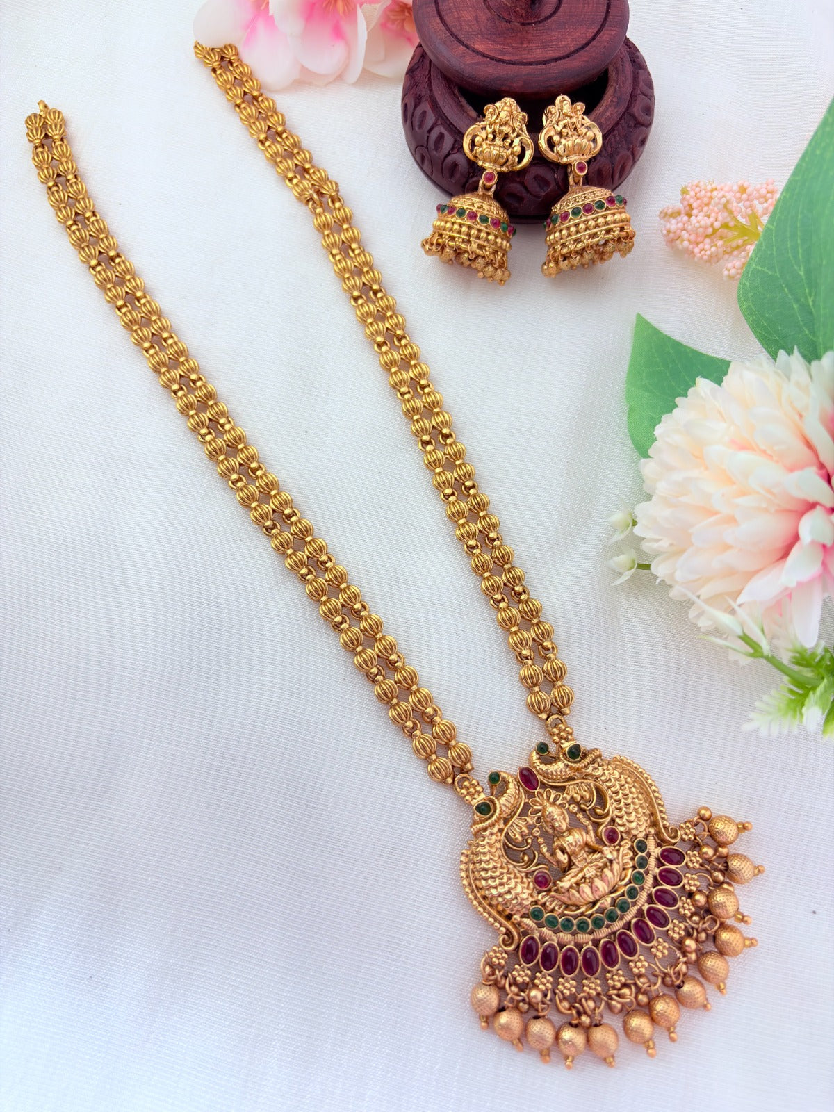 Matte finish Lakshmi pendant haram and matching jumkha adorned with golden beads