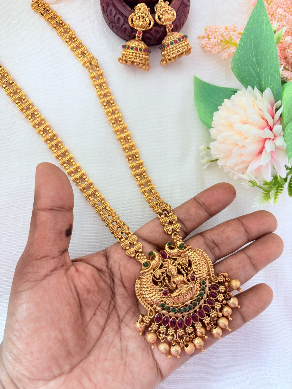 Matte finish Lakshmi pendant haram and matching jumkha adorned with golden beads