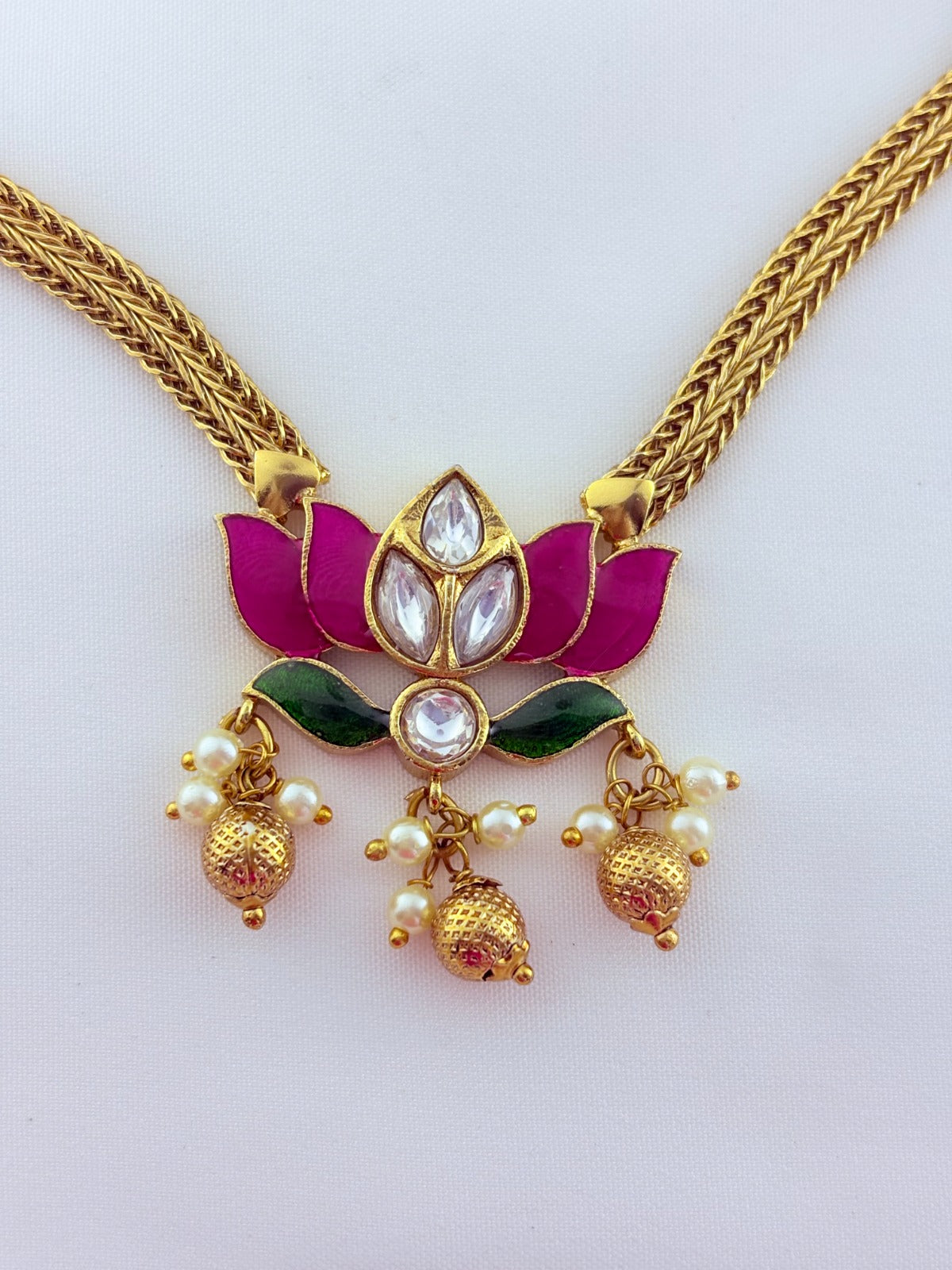 Premium lotus motif neckset highlighted with golden beads and enamel work