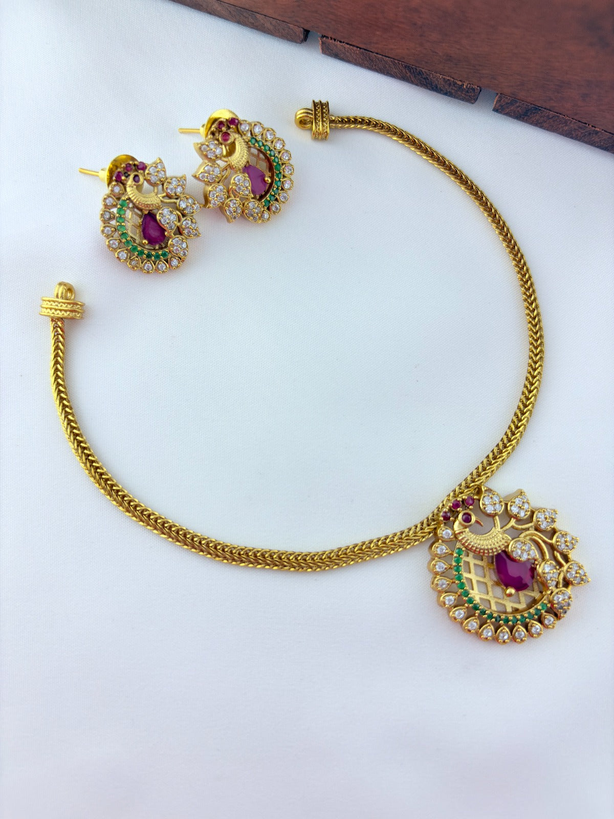 Elegant peacock motif pendant choker paired with matching earrings