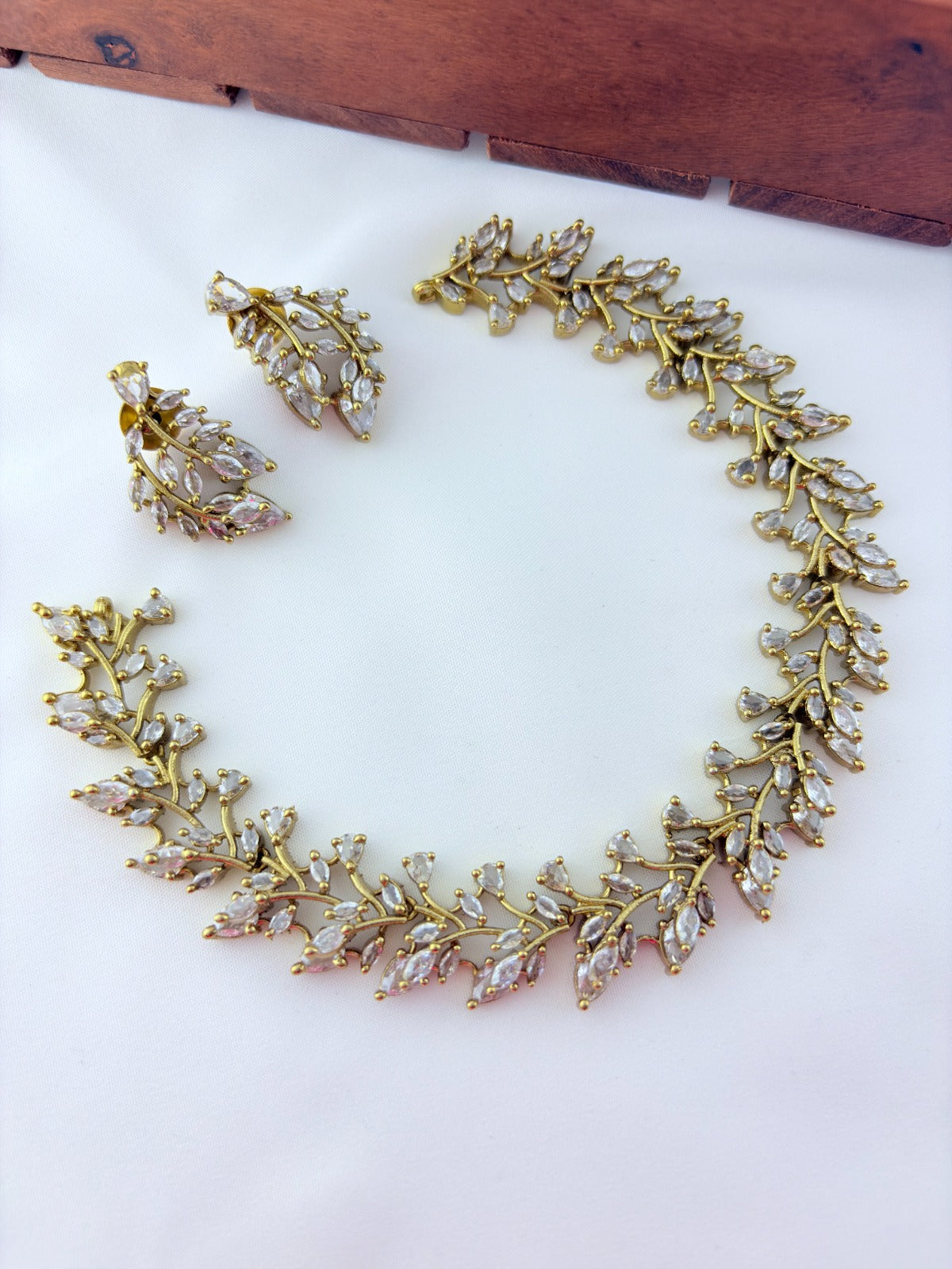 Classic CZ stone necklace featuring a refined antique finish with matching earrings