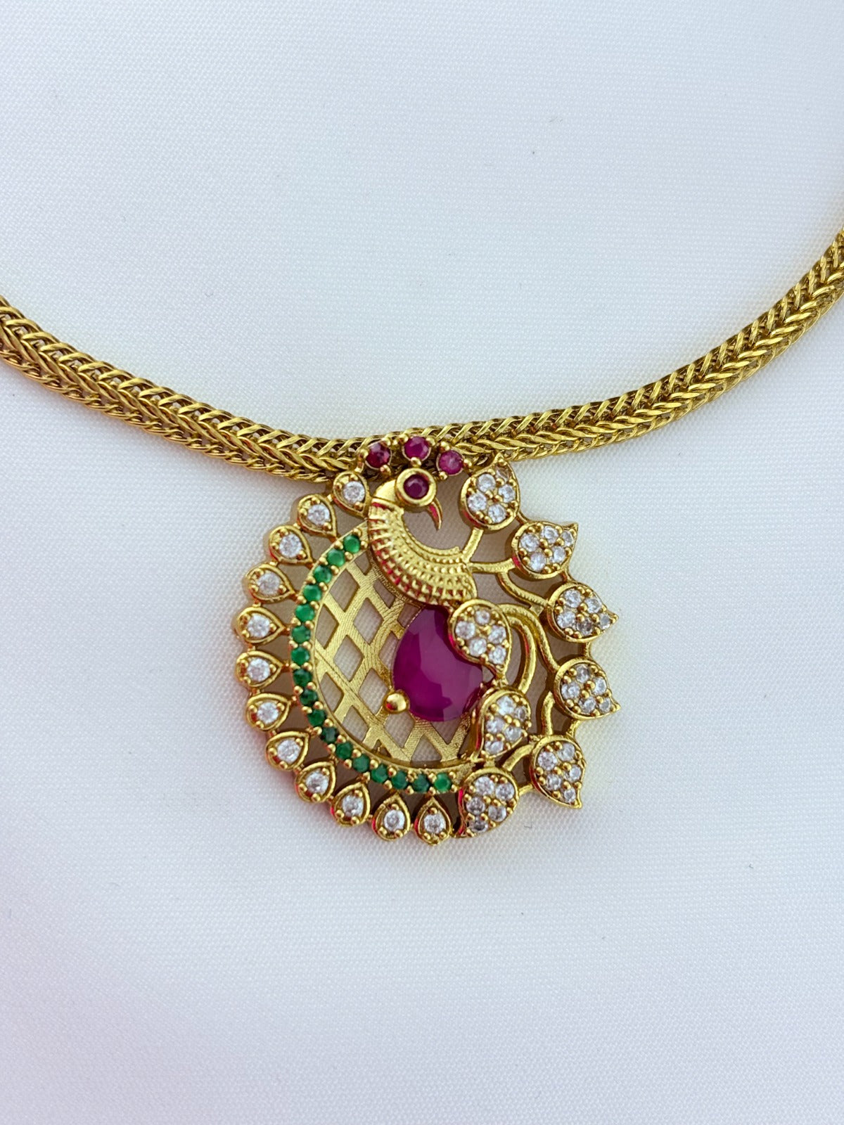 Elegant peacock motif pendant choker paired with matching earrings