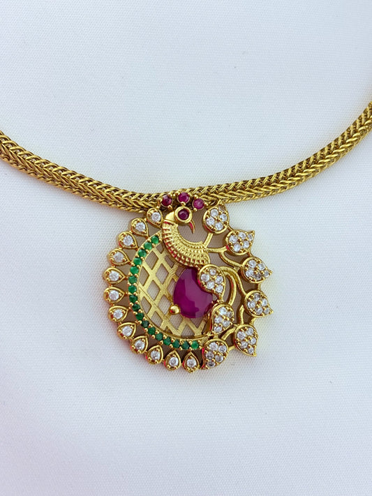 Elegant peacock motif pendant choker paired with matching earrings