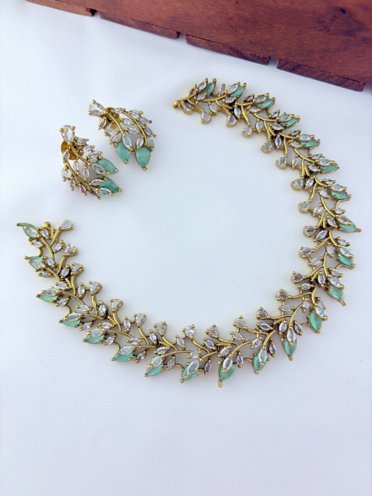 Classic CZ stone necklace featuring a refined antique finish with matching earrings