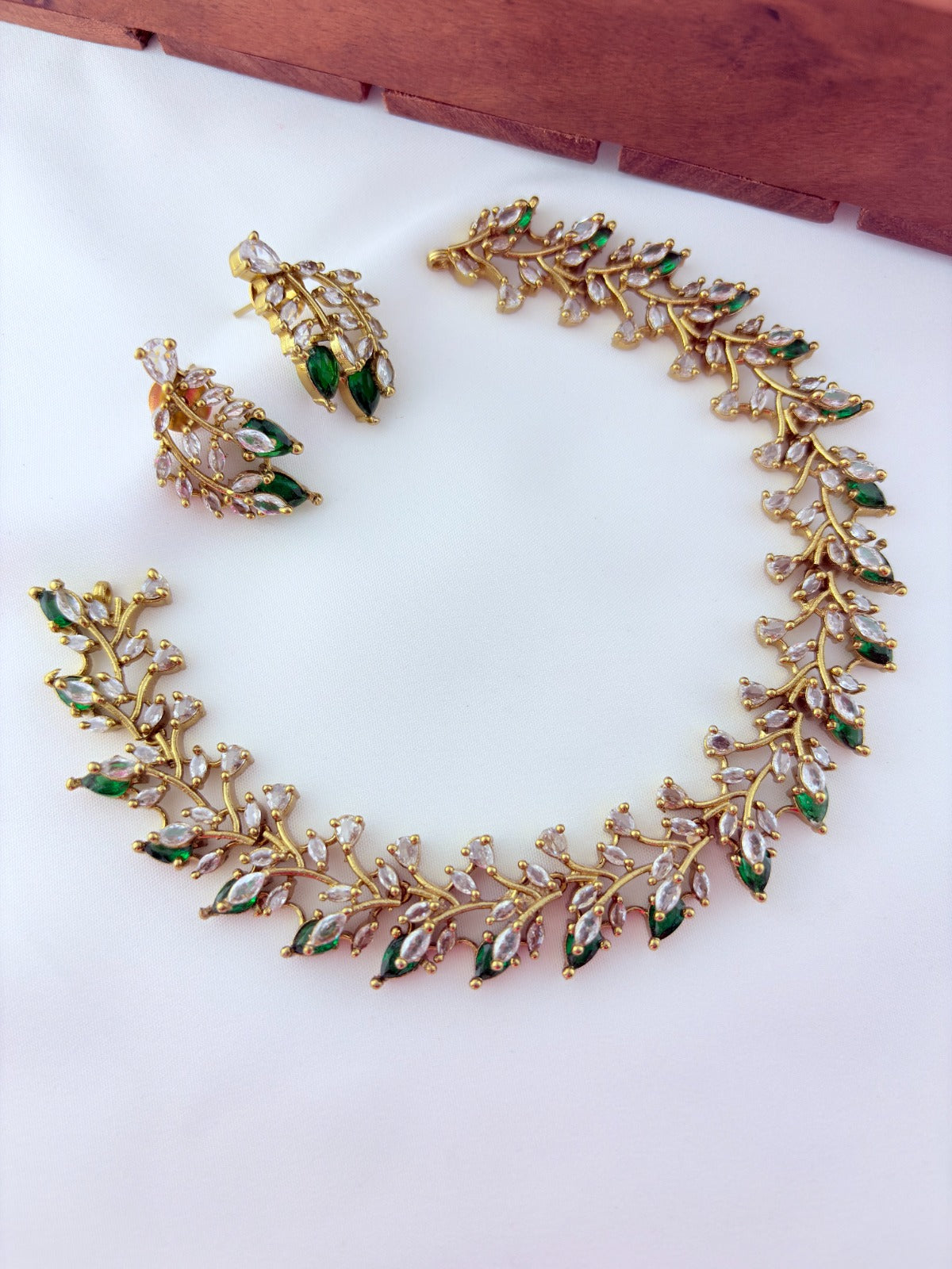 Classic CZ stone necklace featuring a refined antique finish with matching earrings