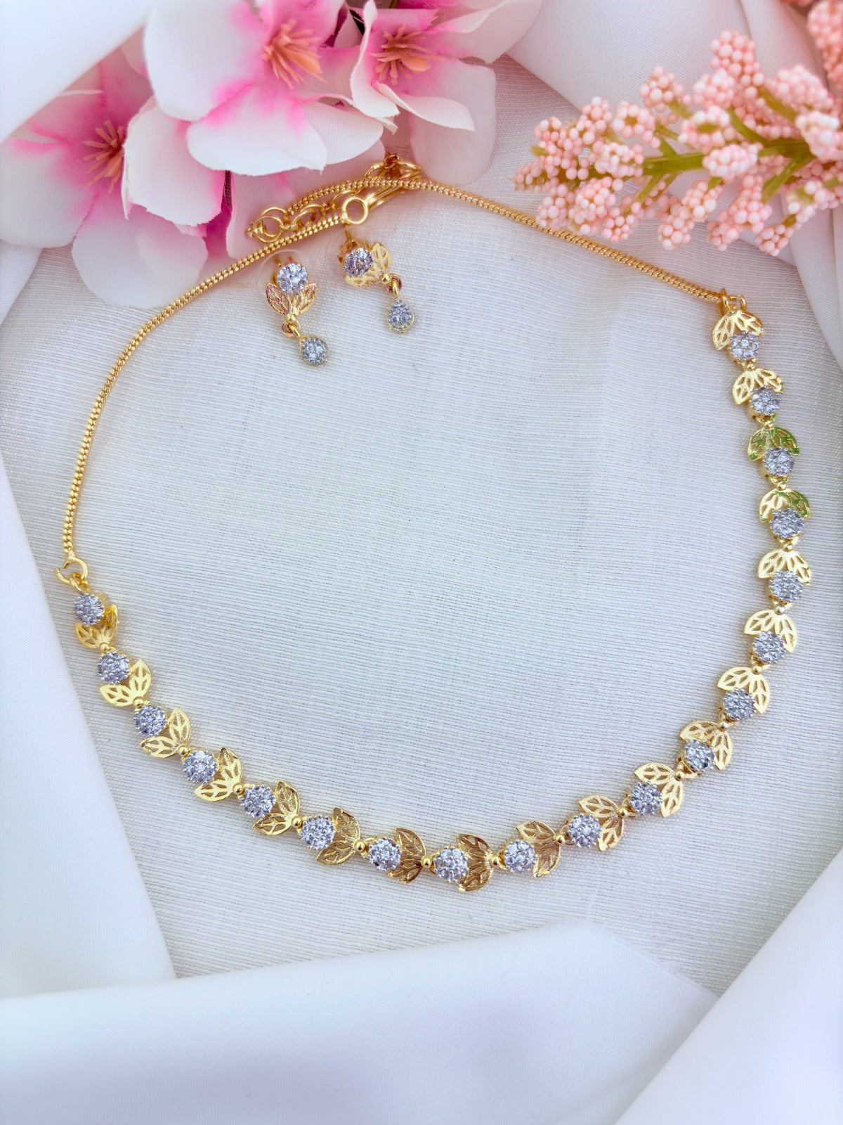 Stylish floral and leaf pattern in premium matte finish necklace adorned with AD stones