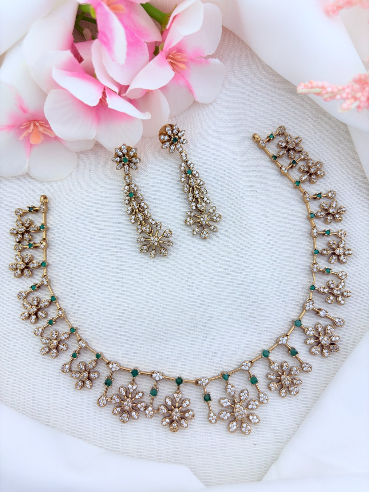 Elegant premium matte finish floral pattern necklace and earrings beautifully adorned with AD stones