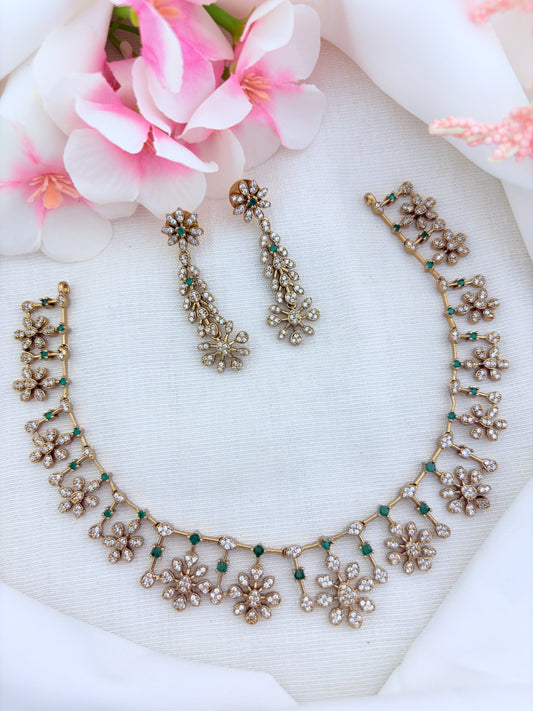 Elegant premium matte finish floral pattern necklace and earrings beautifully adorned with AD stones