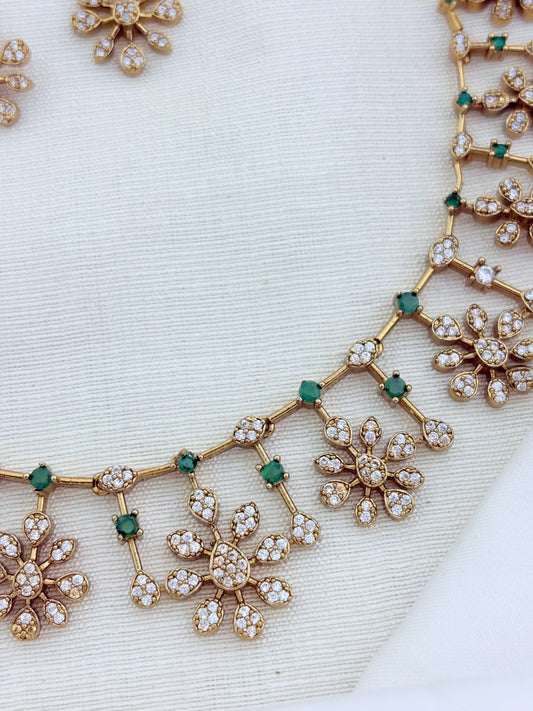 Elegant premium matte finish floral pattern necklace and earrings beautifully adorned with AD stones