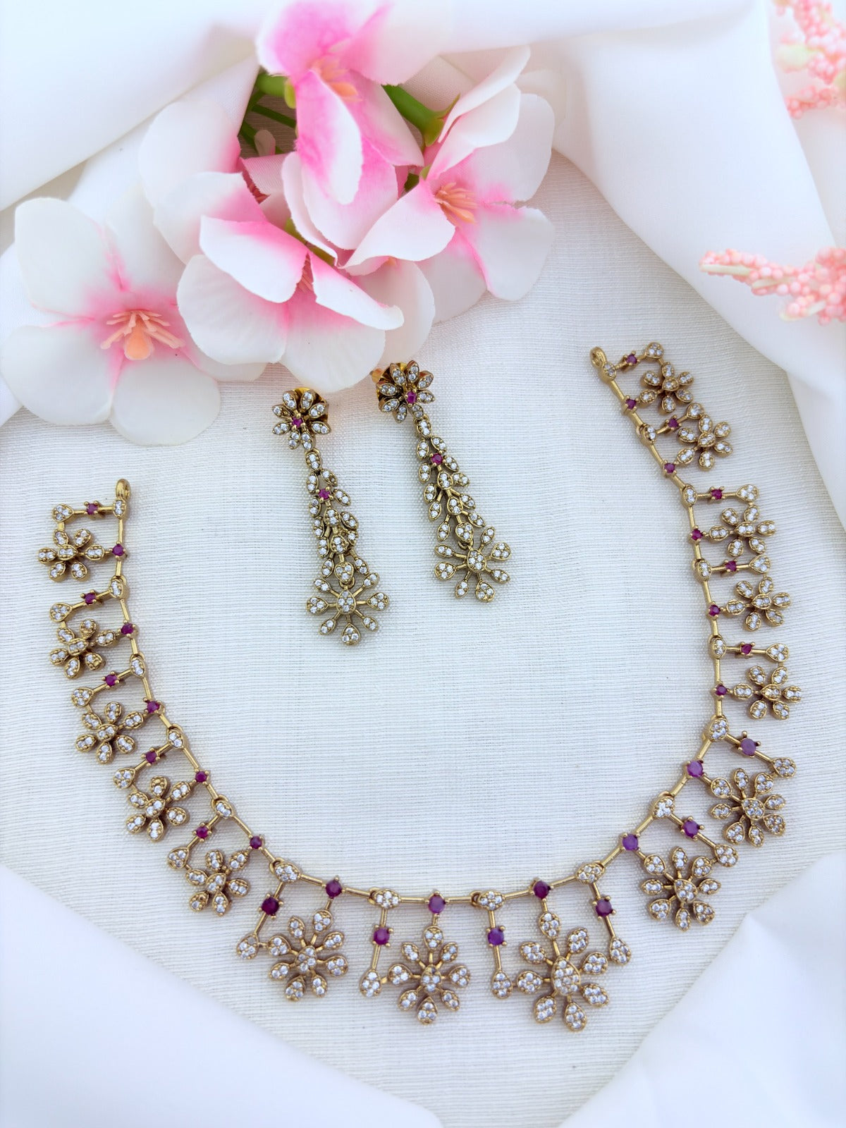 Elegant premium matte finish floral pattern necklace and earrings beautifully adorned with AD stones