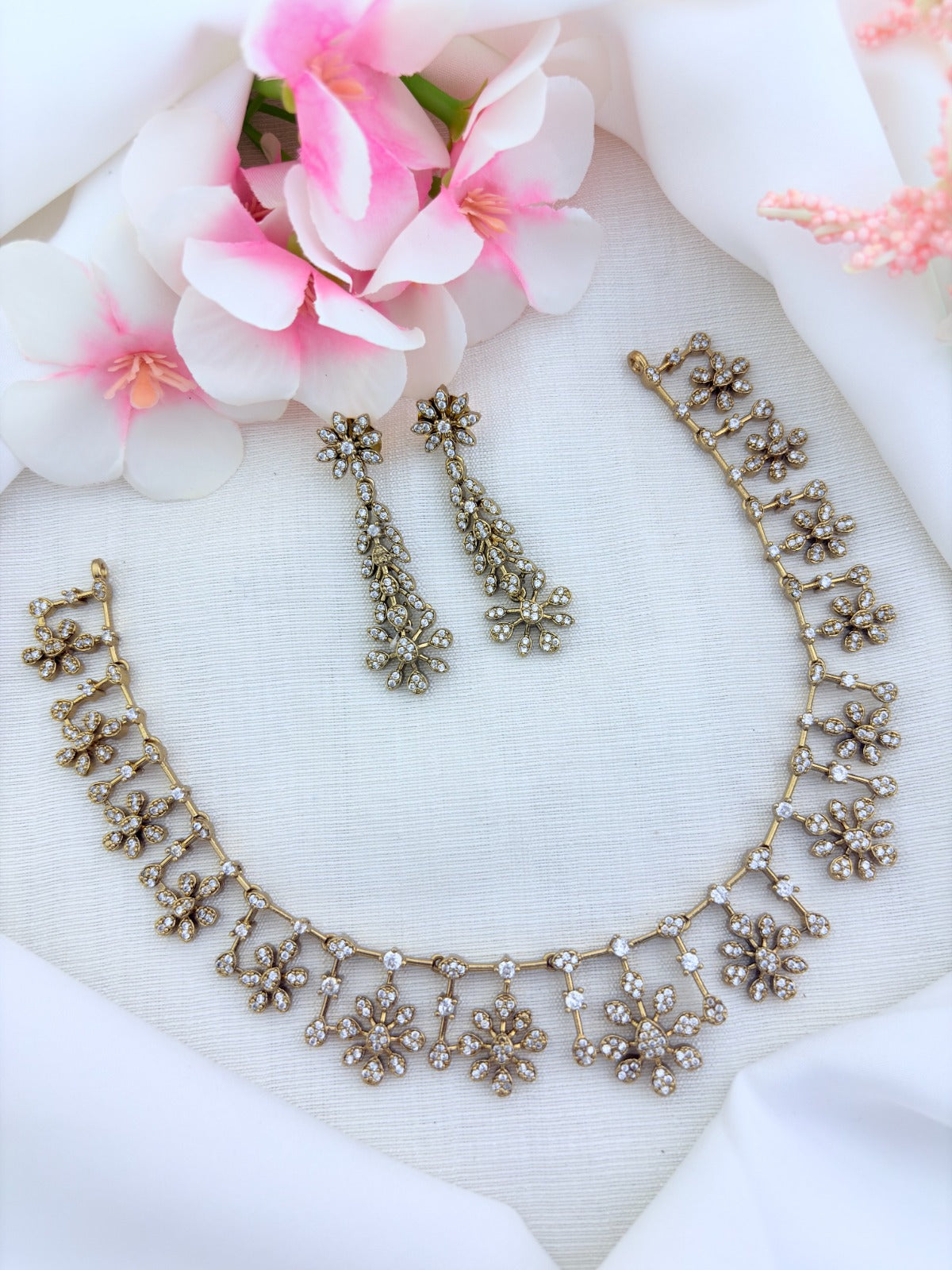 Elegant premium matte finish floral pattern necklace and earrings beautifully adorned with AD stones