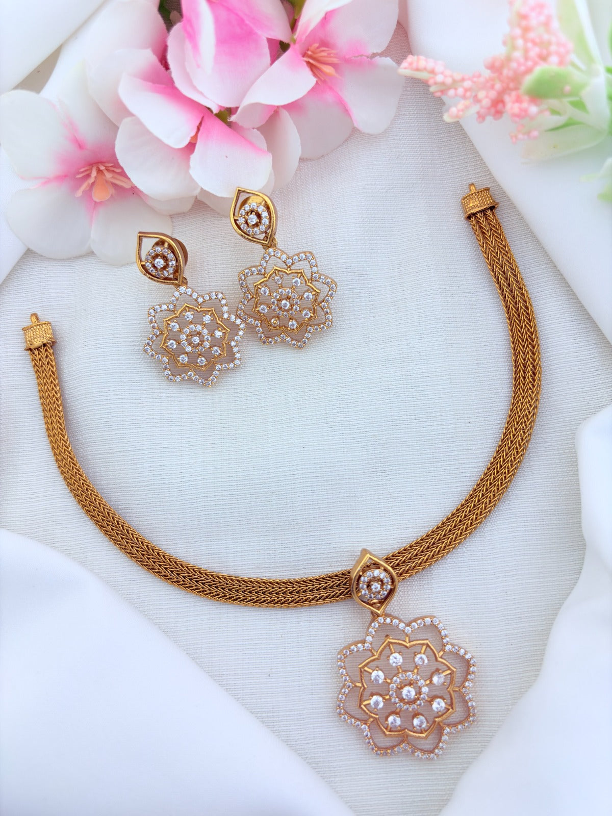 Classic attigai pattern reimagined in modern elegance with AD  stone floral pendant and matching earrings