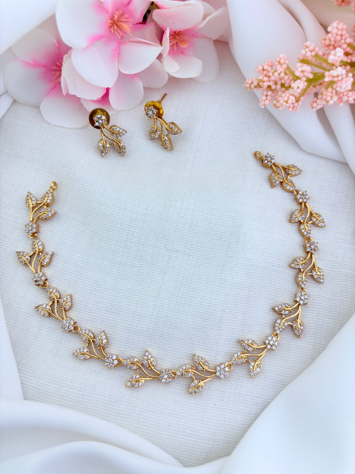 Timeless leaf and floral pattern in premium matte finish beautifully adorned with AD stones