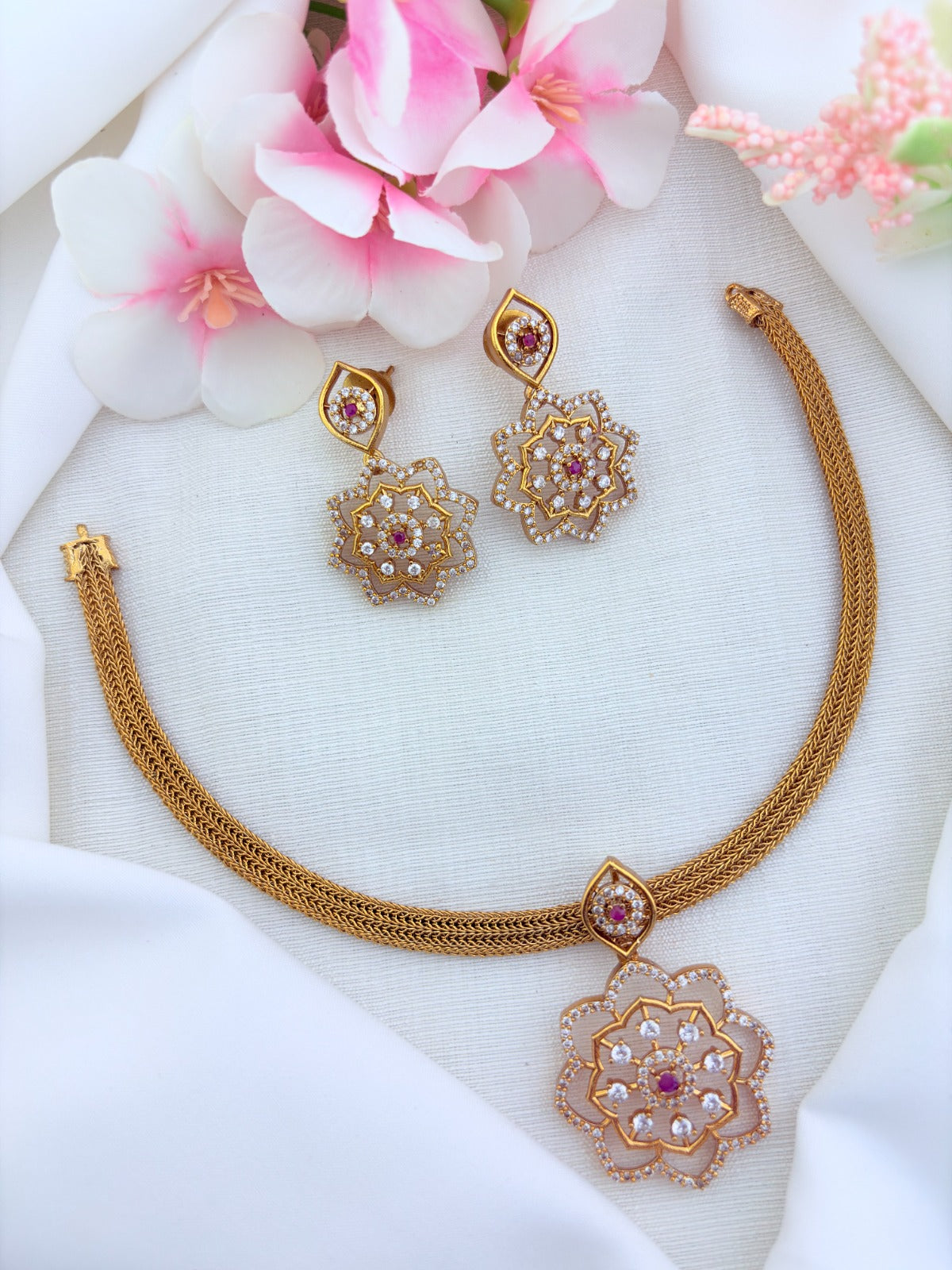 Classic attigai pattern reimagined in modern elegance with AD  stone floral pendant and matching earrings