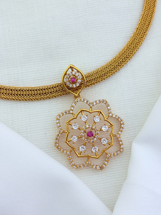 Classic attigai pattern reimagined in modern elegance with AD  stone floral pendant and matching earrings