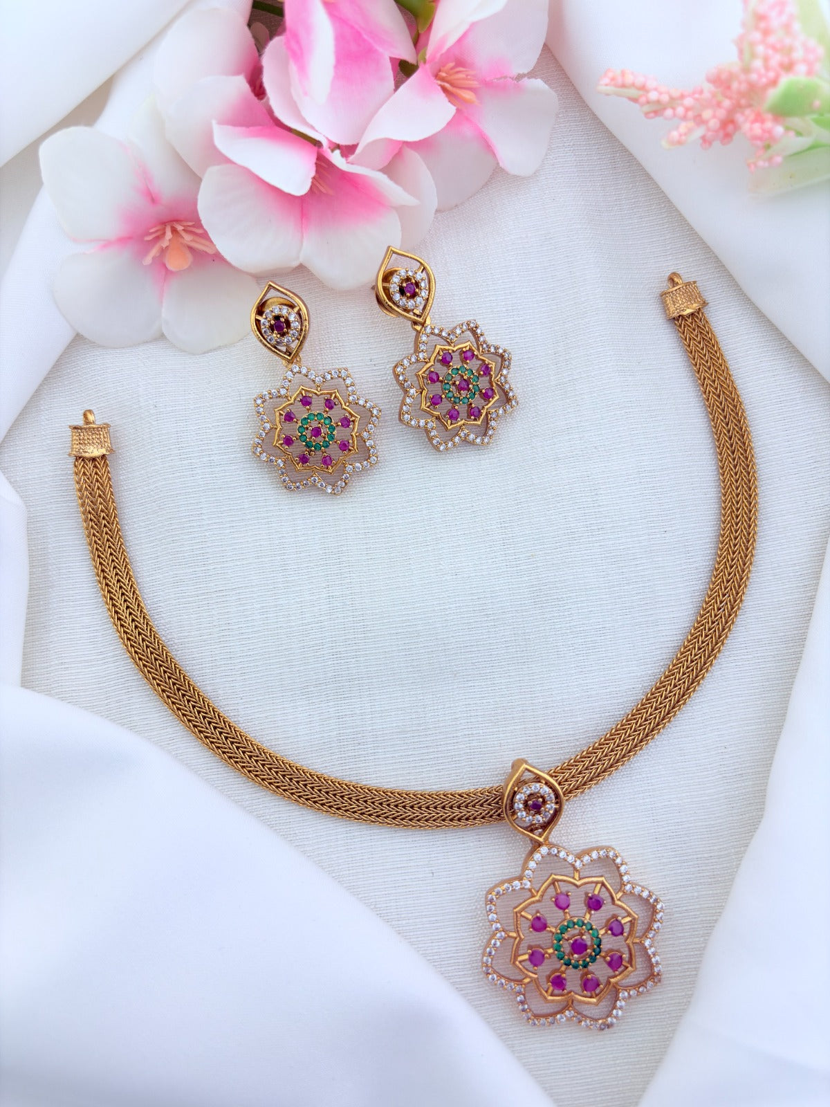 Classic attigai pattern reimagined in modern elegance with AD  stone floral pendant and matching earrings