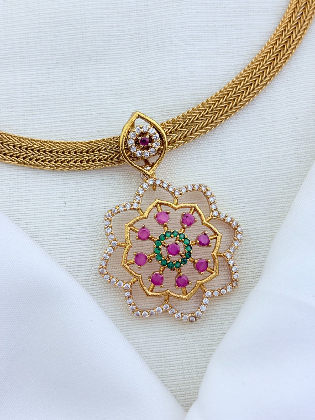 Classic attigai pattern reimagined in modern elegance with AD  stone floral pendant and matching earrings