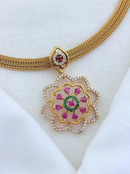 Classic attigai pattern reimagined in modern elegance with AD  stone floral pendant and matching earrings