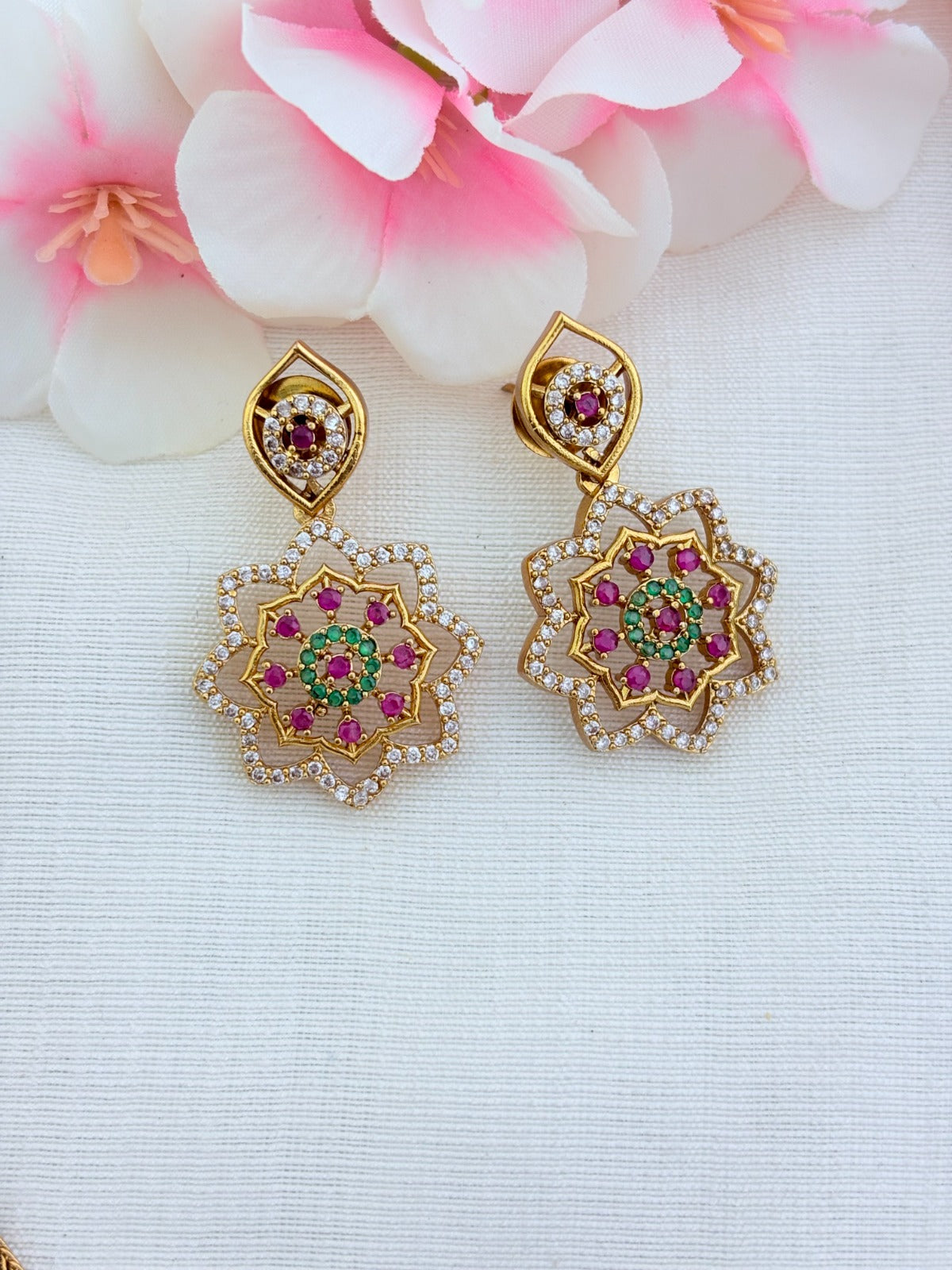 Classic attigai pattern reimagined in modern elegance with AD  stone floral pendant and matching earrings