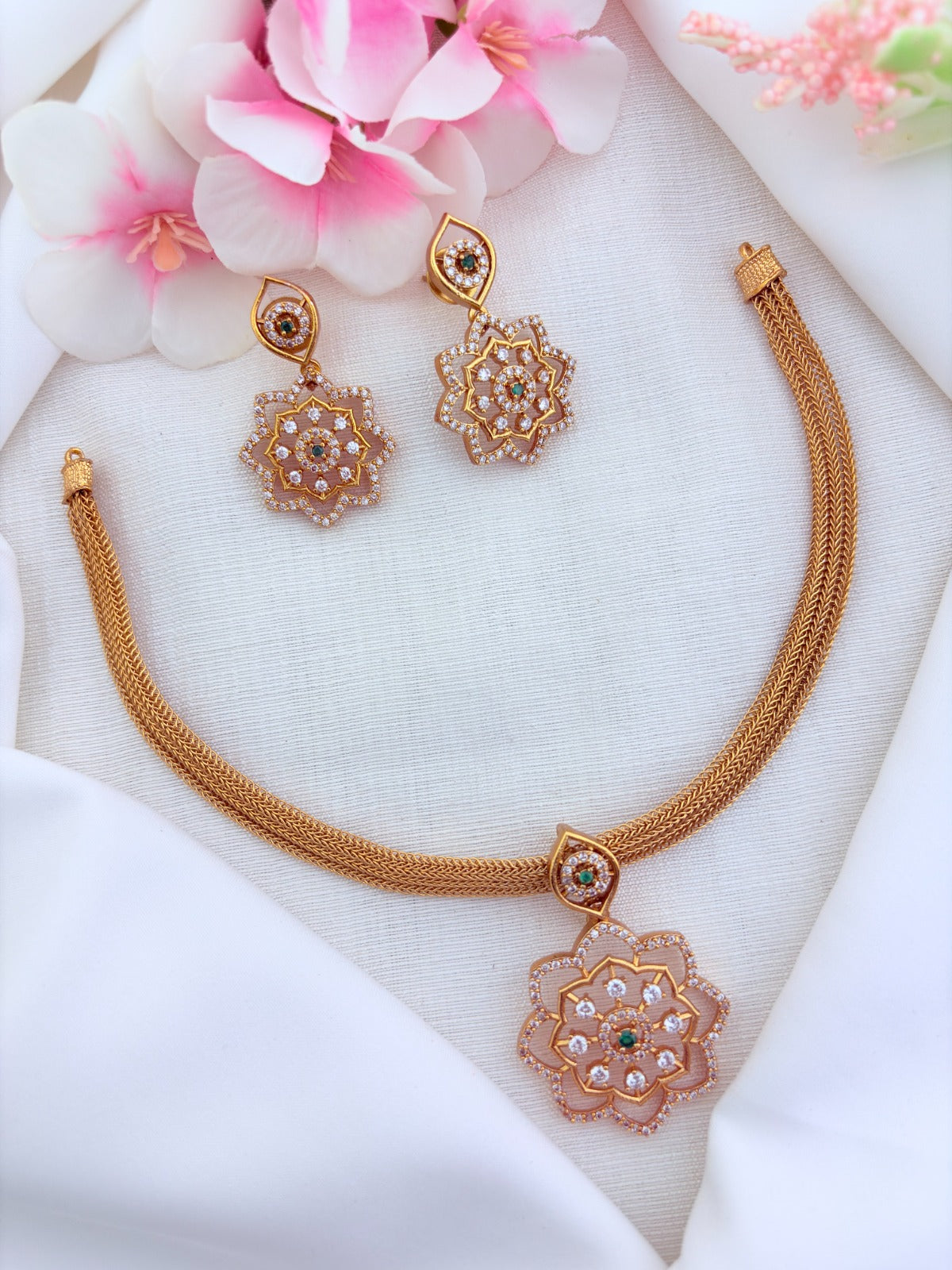 Classic attigai pattern reimagined in modern elegance with AD  stone floral pendant and matching earrings