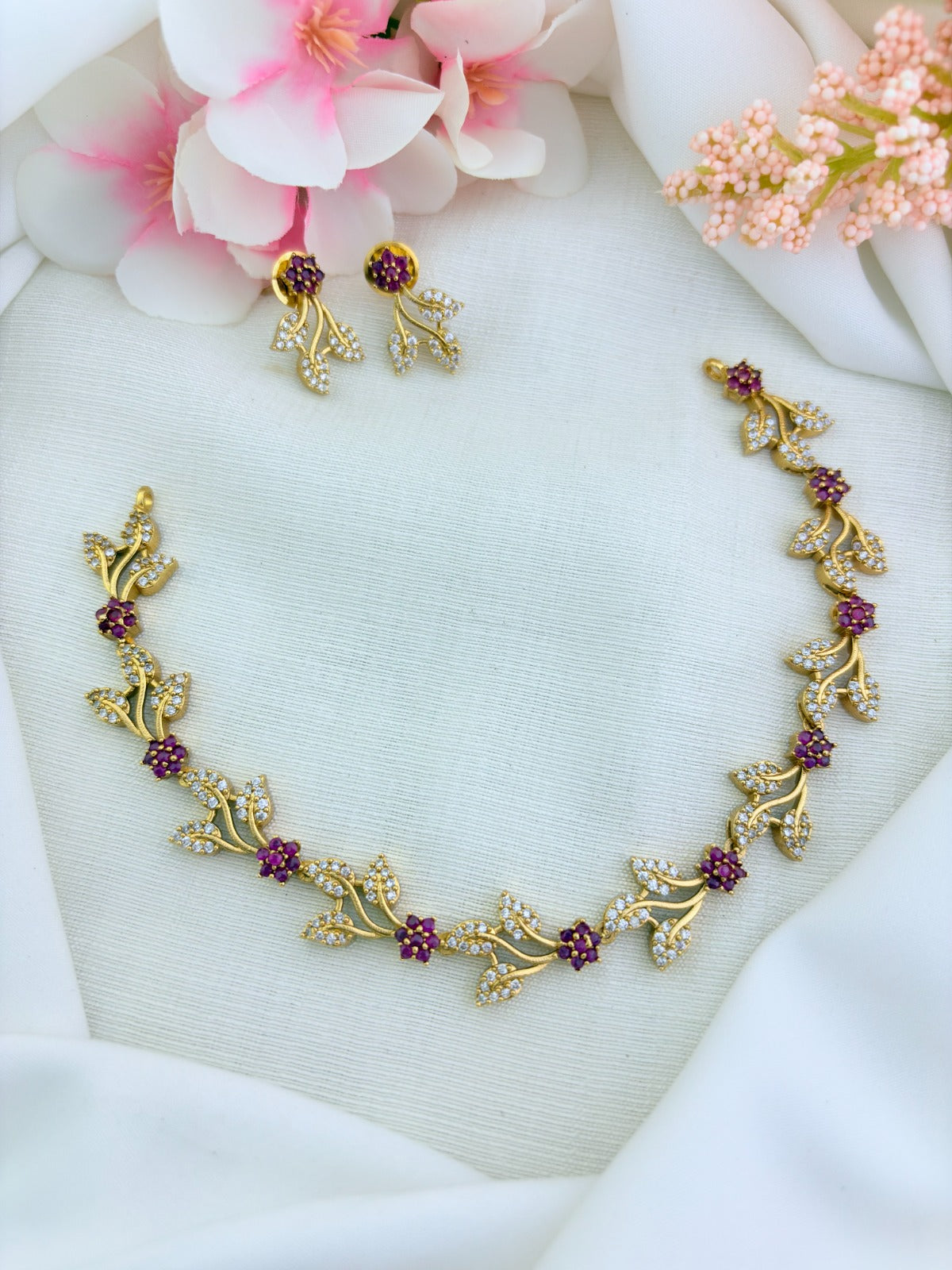 Timeless leaf and floral pattern in premium matte finish beautifully adorned with AD stones