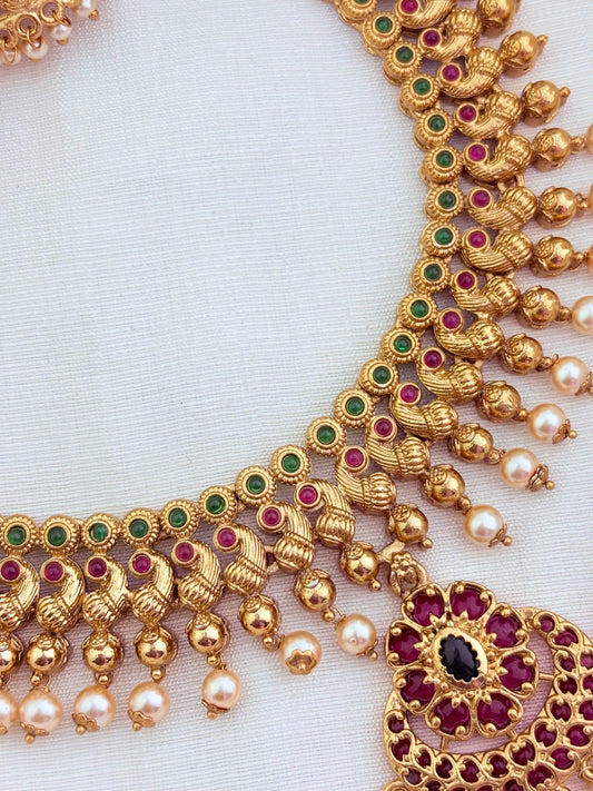 Elegant matte finish neckset featuring a peacock motif, pearl drops and matching jhumka