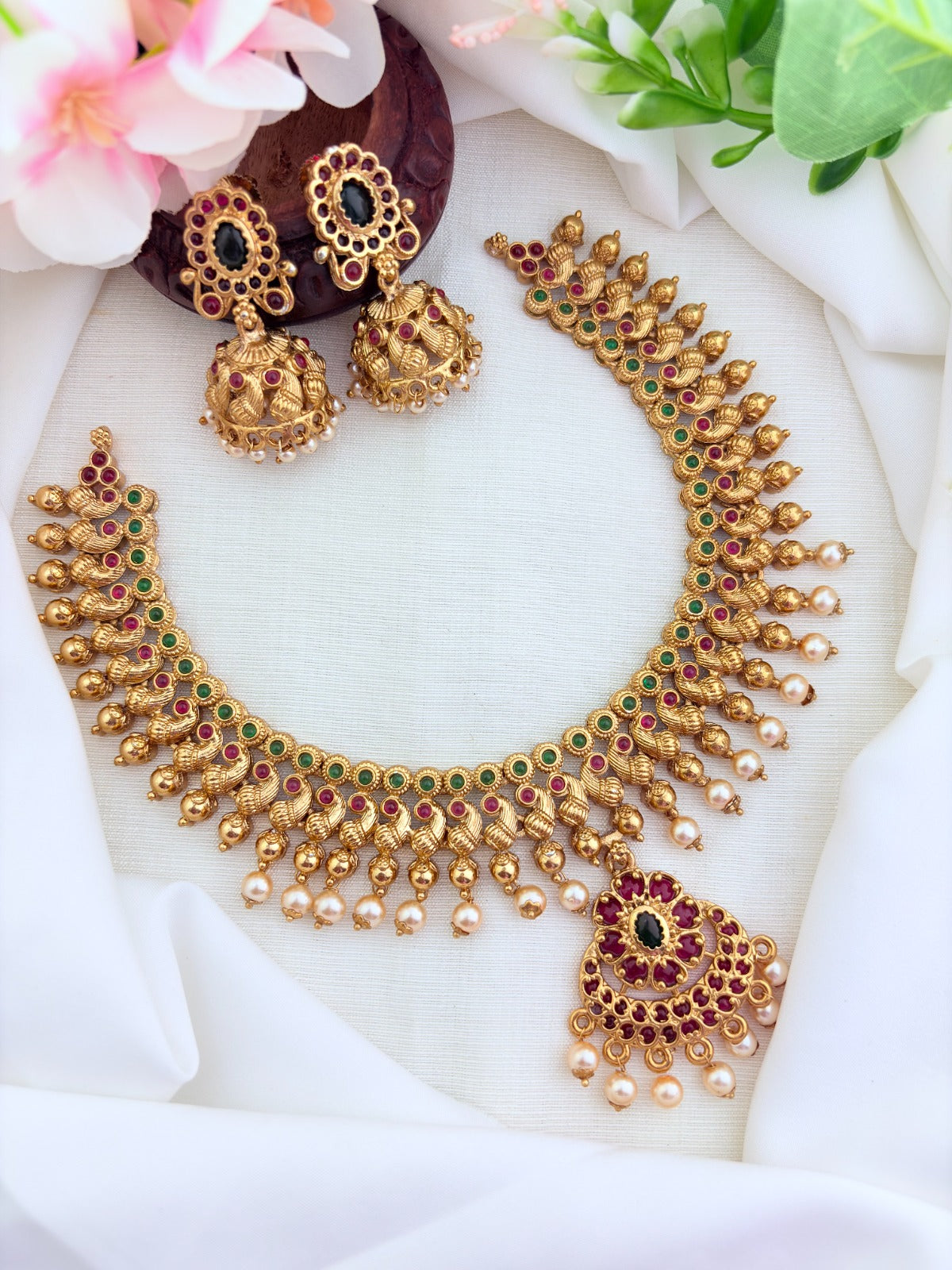 Elegant matte finish neckset featuring a peacock motif, pearl drops and matching jhumka