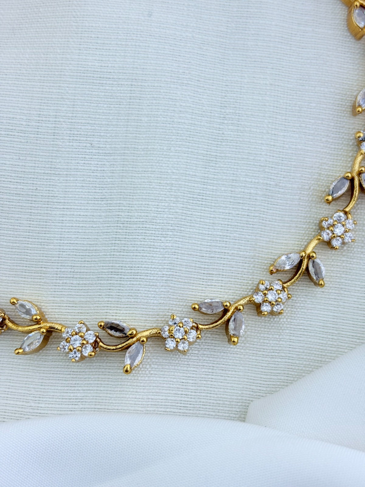 Premium matte finish neckset featuring floral and leaf motifs in a single design, adorned with AD & CZ stones and matching earrings