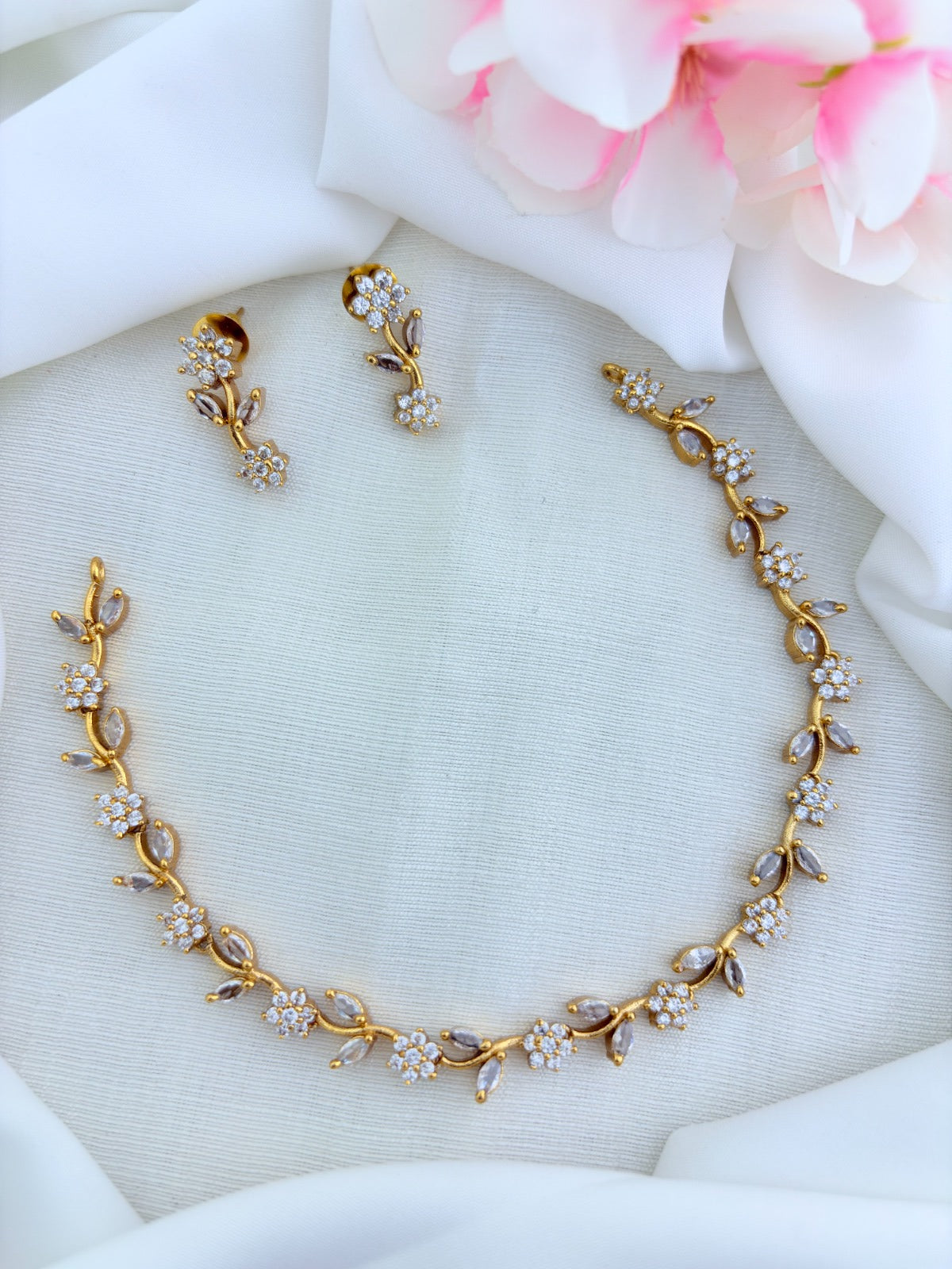 Premium matte finish neckset featuring floral and leaf motifs in a single design, adorned with AD & CZ stones and matching earrings