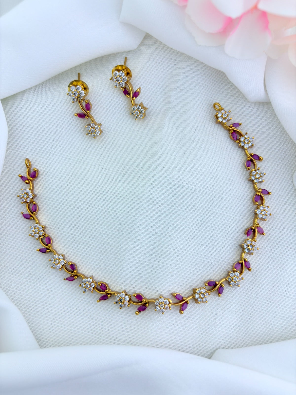 Premium matte finish neckset featuring floral and leaf motifs in a single design, adorned with AD & CZ stones and matching earrings