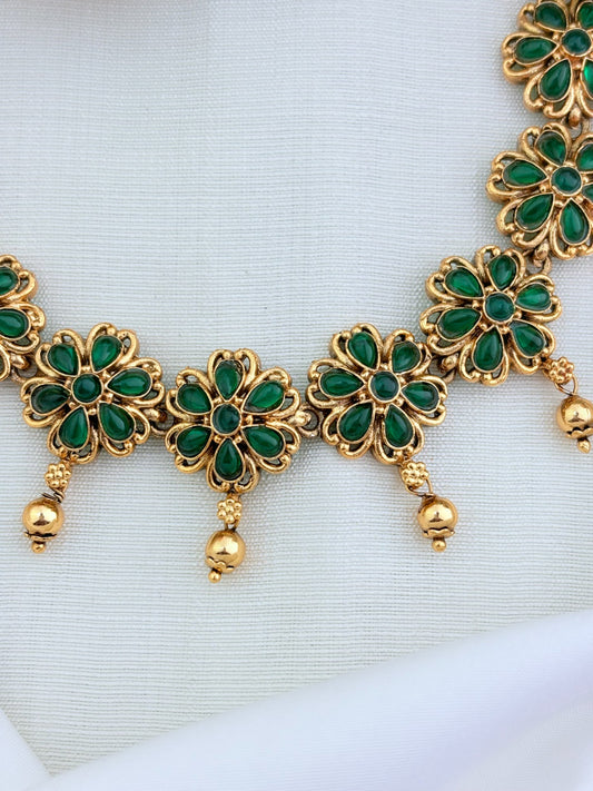Matte finish floral pattern neckset and jhumka adorned with classic stones and golden beads