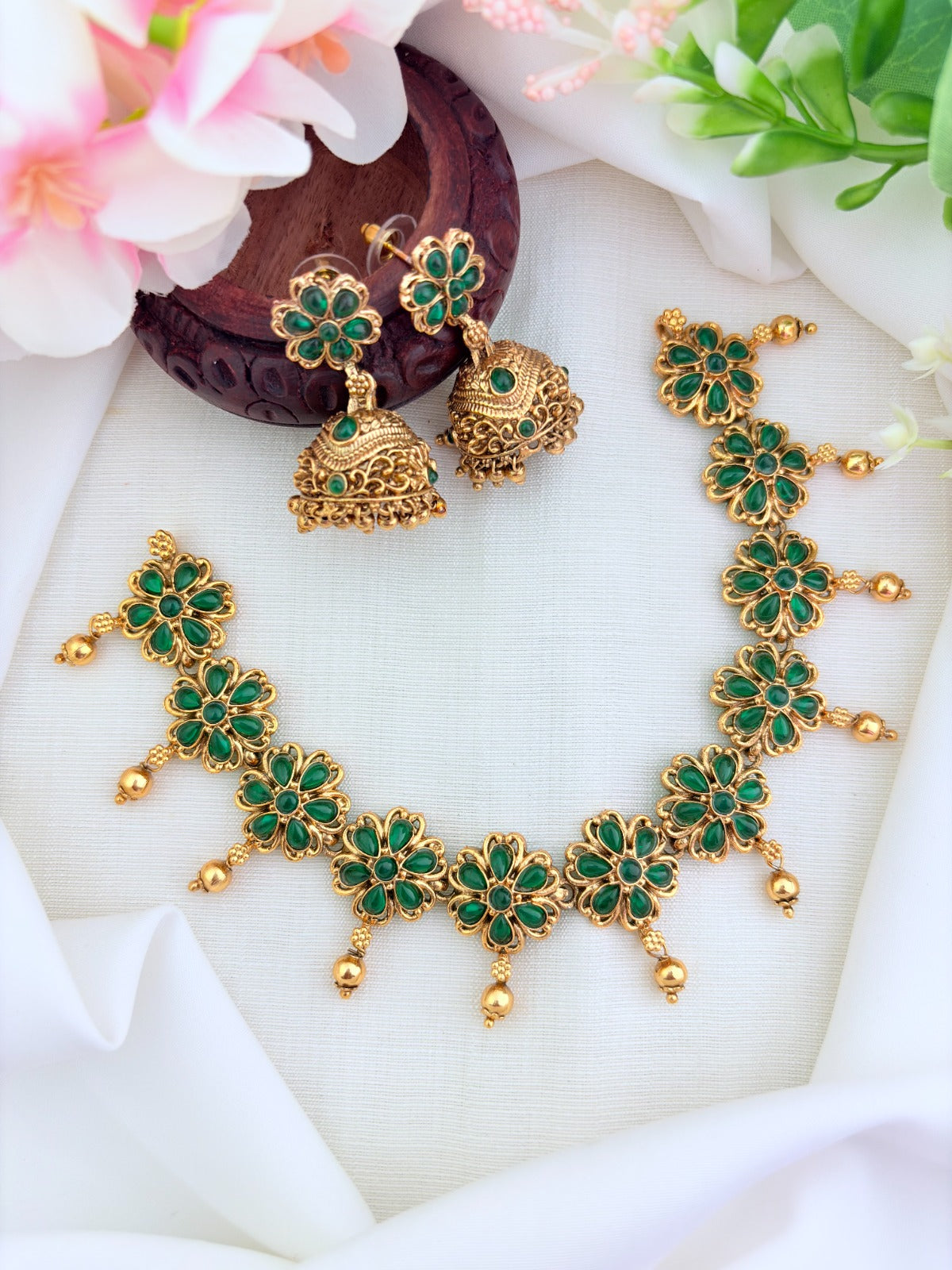 Matte finish floral pattern neckset and jhumka adorned with classic stones and golden beads