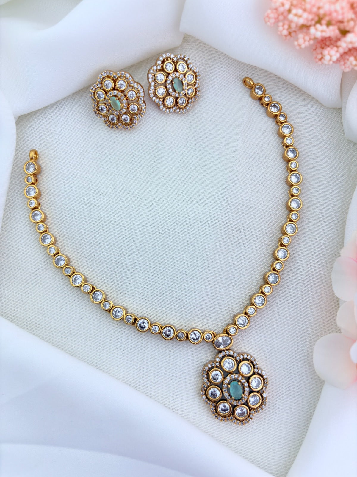 Classic matte finish floral pendant necklace and earrings  adorned with  CZ stones