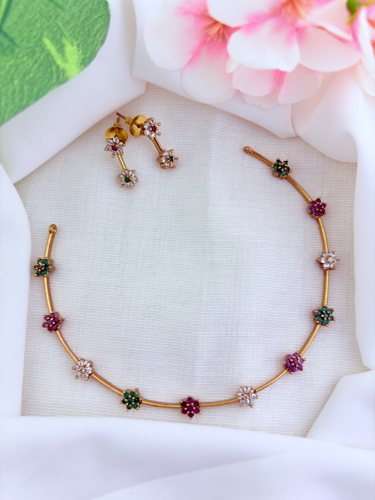 Premium matte finish floral pattern neckset adorned with classic AD stones and matching earrings