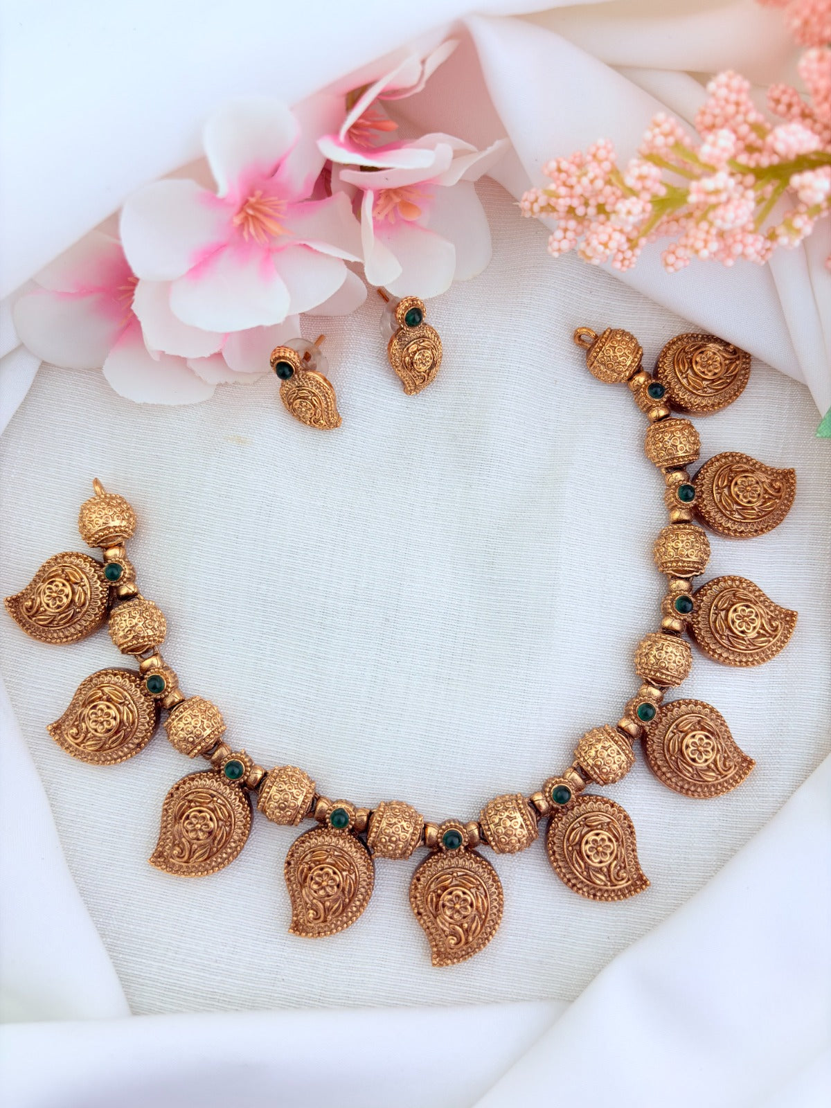 Classic matte finish necklace featuring mango motif and golden balls with matching earrings