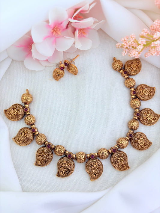 Classic matte finish necklace featuring mango motif and golden balls with matching earrings