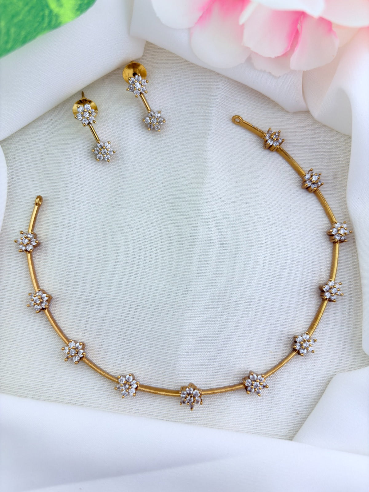 Premium matte finish floral pattern neckset adorned with classic AD stones and matching earrings