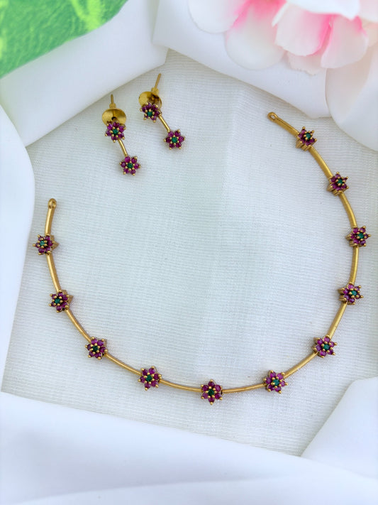 Premium matte finish floral pattern neckset adorned with classic AD stones and matching earrings