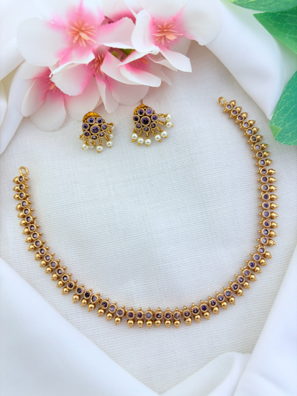 Premium matte finish AD stone necklace and earrings beautifully crafted with pearl drops