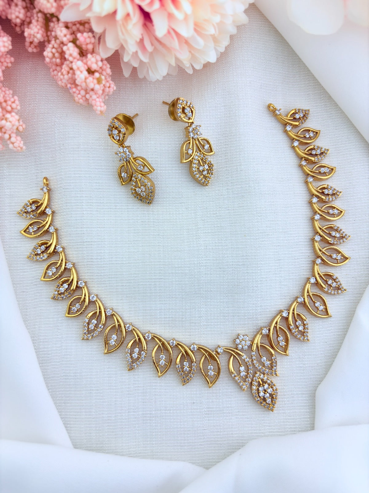 Elegant leaf motif design in premium matte finish necklace adorned with AD stones