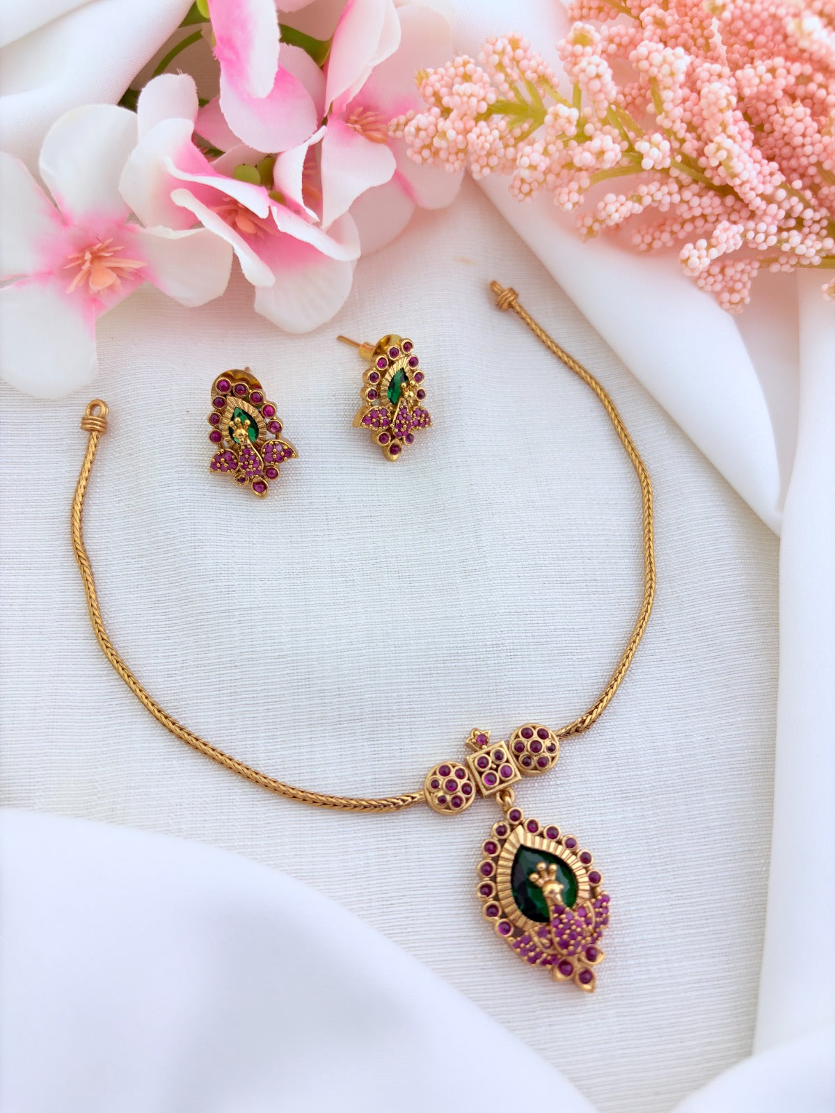 Beautifully crafted peacock pendant featuring AD stones in premium matte finish with matching earrings