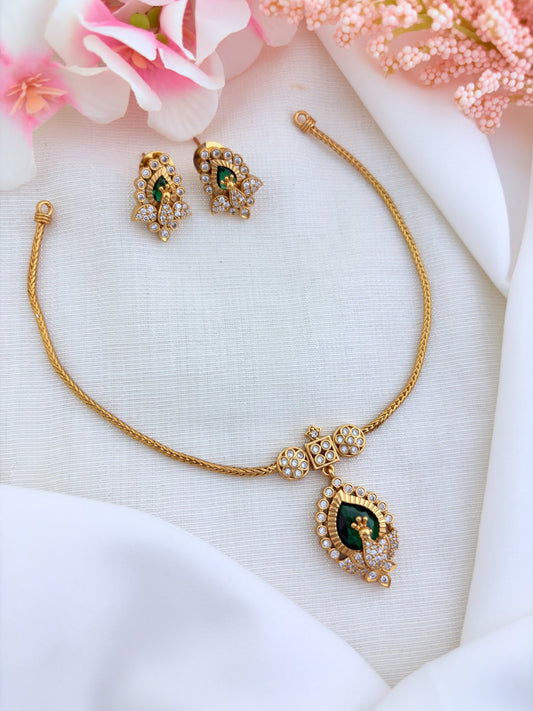 Beautifully crafted peacock pendant featuring AD stones in premium matte finish with matching earrings