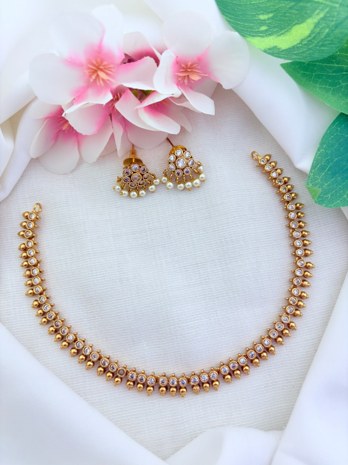 Premium matte finish AD stone necklace and earrings beautifully crafted with pearl drops