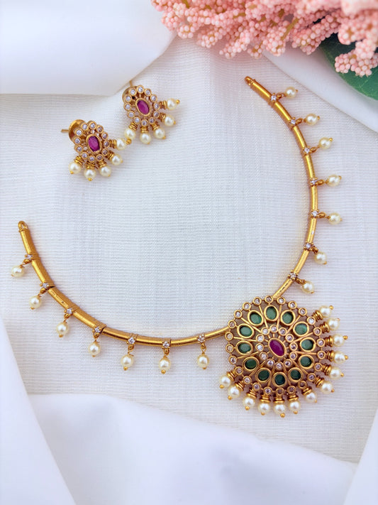 Premium matte finish necklace and earrings adorned with classic stones and pearl drops