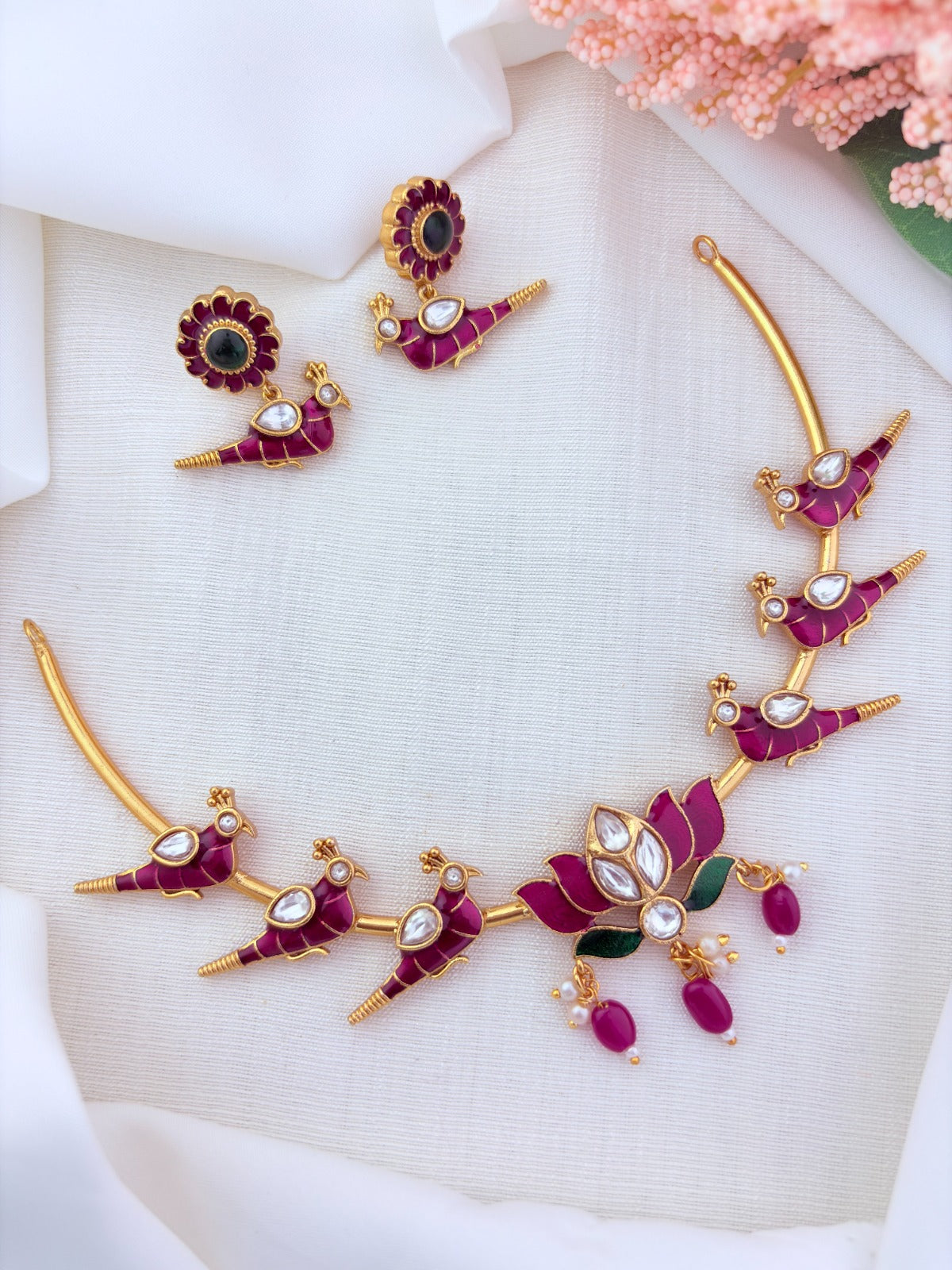 Peacock and lotus design combined in a single premium matte necklace with rich enamel detailing and matching earrings