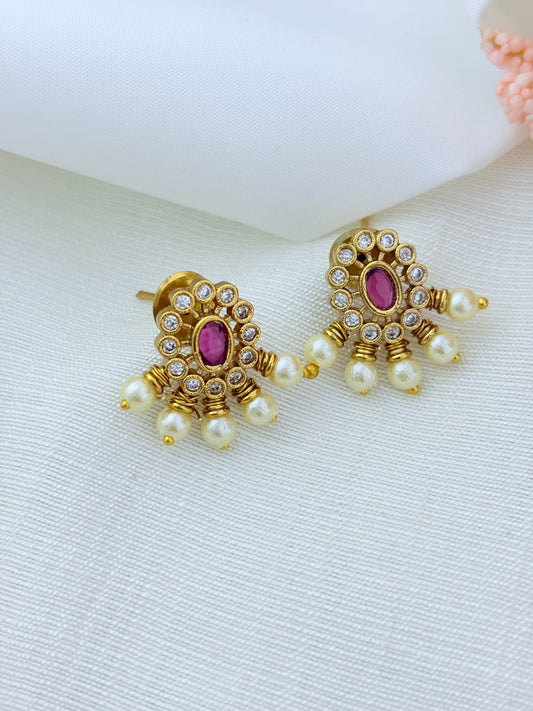 Premium matte finish necklace and earrings adorned with classic stones and pearl drops