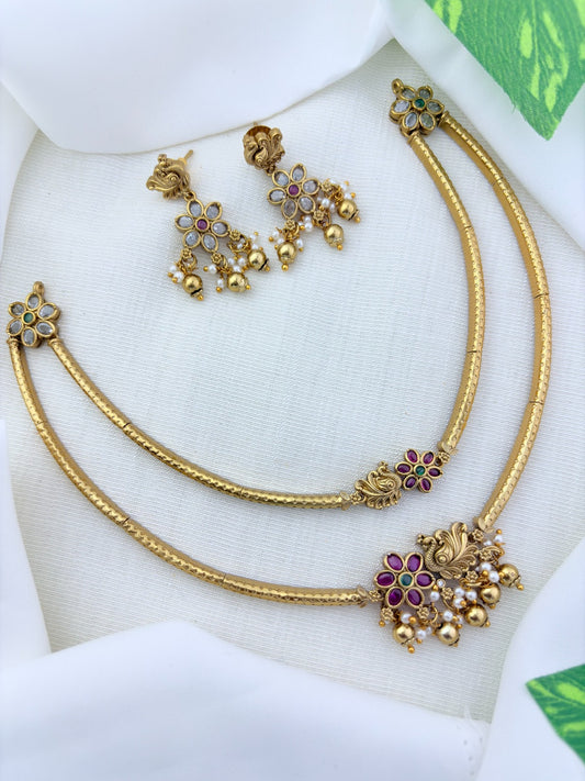 Classic layered necklace showcasing peacock and floral artistry, enriched with stones and highlighted pearl & gold drops