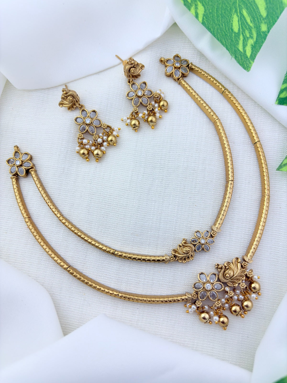 Classic layered necklace showcasing peacock and floral artistry, enriched with stones and highlighted pearl & gold drops